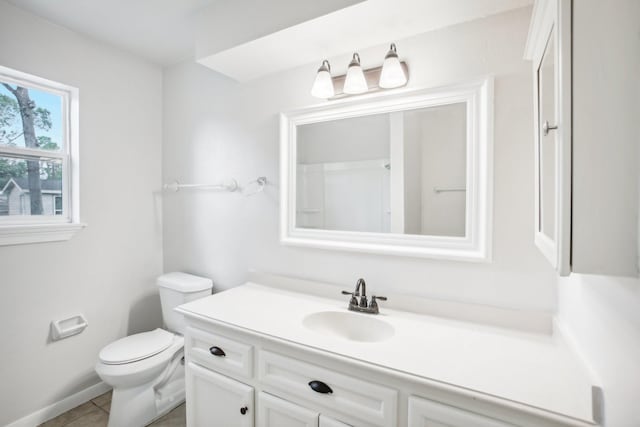 bathroom featuring tile patterned flooring, vanity, and toilet