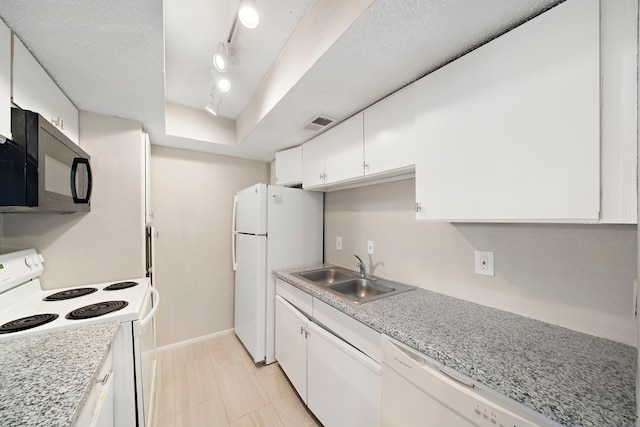 kitchen featuring white cabinetry, sink, track lighting, white appliances, and a tray ceiling