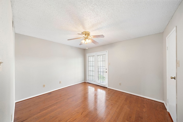 spare room featuring ceiling fan, hardwood / wood-style floors, and a textured ceiling