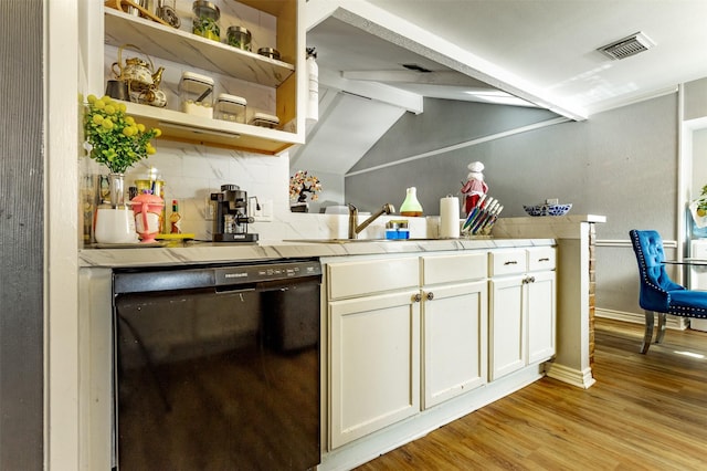 kitchen with tasteful backsplash, light hardwood / wood-style flooring, dishwasher, white cabinetry, and lofted ceiling