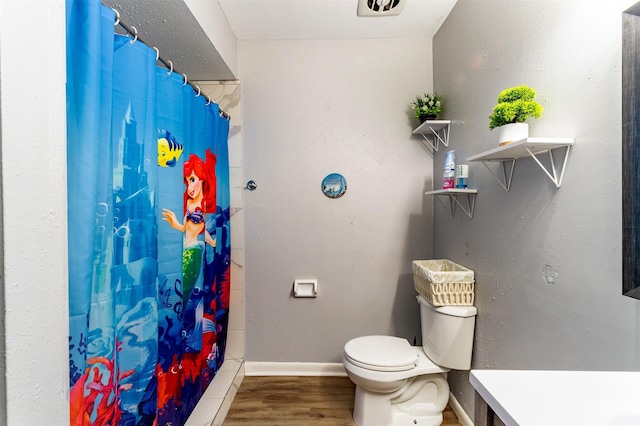 bathroom with walk in shower, toilet, vanity, and hardwood / wood-style flooring