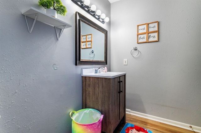 bathroom featuring vanity and hardwood / wood-style flooring