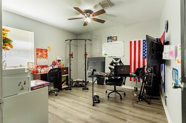 home office featuring light hardwood / wood-style flooring and ceiling fan