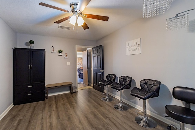 misc room with ceiling fan with notable chandelier and dark hardwood / wood-style flooring