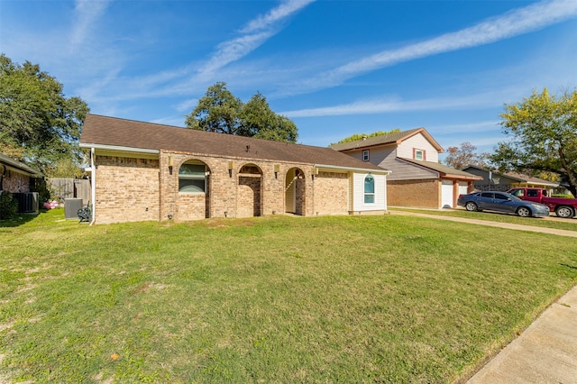 ranch-style house featuring cooling unit and a front lawn