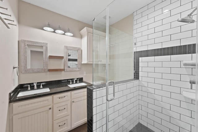 bathroom with vanity and a shower with door