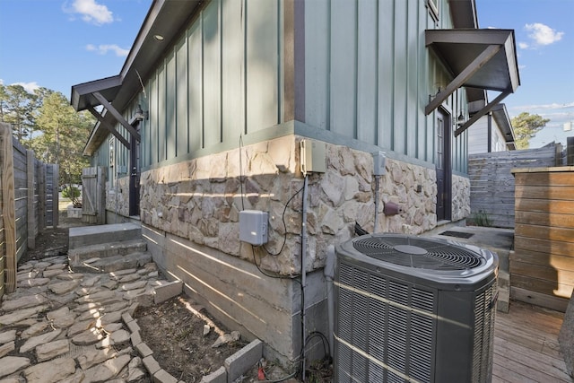 view of home's exterior with central AC unit and a wooden deck