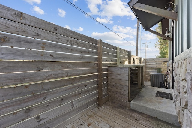 wooden terrace featuring central AC unit