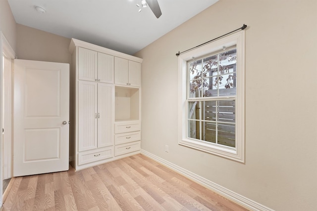 unfurnished bedroom with ceiling fan and light hardwood / wood-style flooring