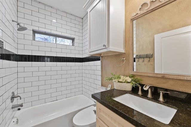 full bathroom with vanity, tiled shower / bath combo, and toilet