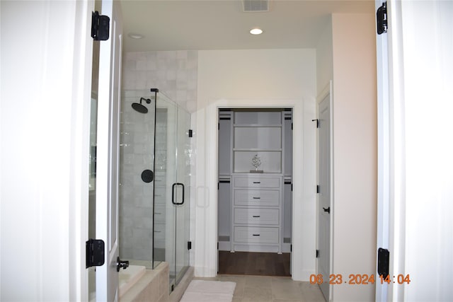 bathroom with tile patterned flooring and walk in shower