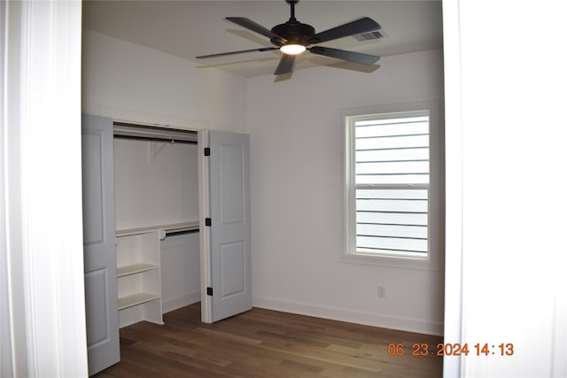 unfurnished bedroom with ceiling fan, dark hardwood / wood-style floors, and a closet