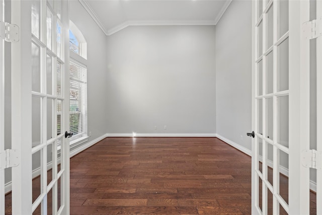 unfurnished room featuring crown molding, dark wood-type flooring, and french doors