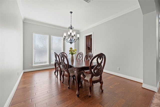 dining area with a notable chandelier, dark hardwood / wood-style flooring, and crown molding