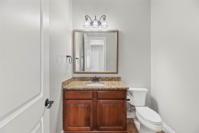 bathroom with tile patterned floors, vanity, and toilet