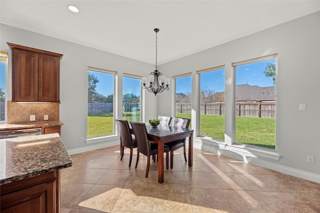 dining space with a chandelier, crown molding, and a healthy amount of sunlight