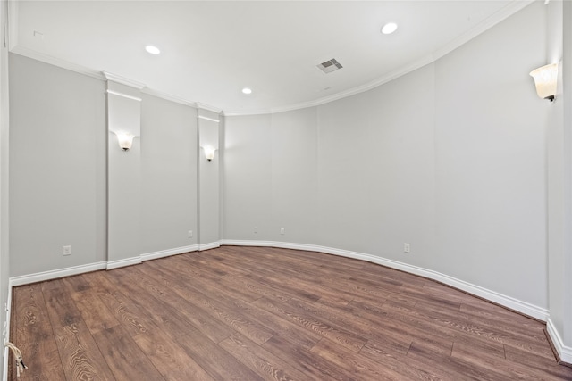 empty room with crown molding and wood-type flooring