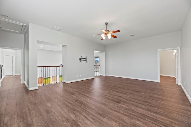 unfurnished living room with dark hardwood / wood-style flooring and ceiling fan