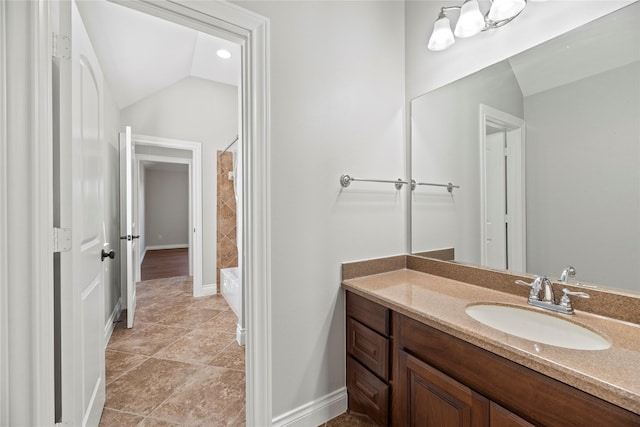 bathroom with shower with separate bathtub, vanity, vaulted ceiling, and tile patterned floors