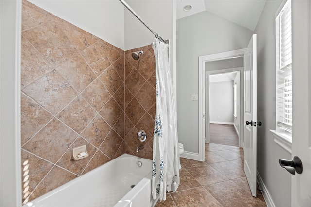 bathroom with tile patterned flooring, shower / bath combo, toilet, and lofted ceiling