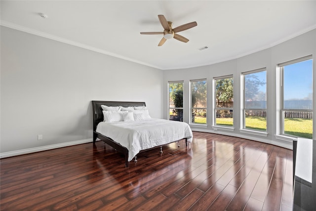 bedroom featuring ceiling fan, dark hardwood / wood-style floors, and crown molding