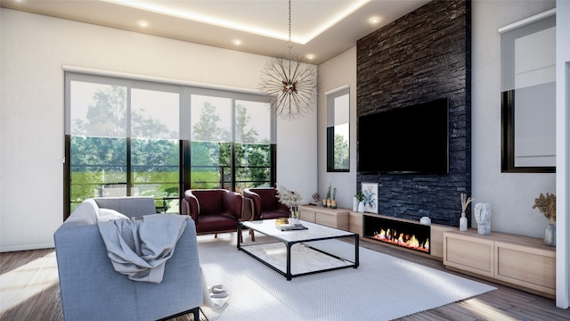 living room featuring a stone fireplace and hardwood / wood-style flooring