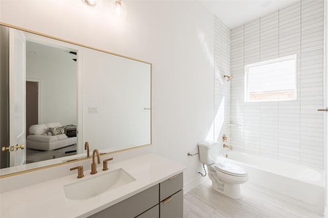 bathroom featuring vanity, toilet, and bathing tub / shower combination