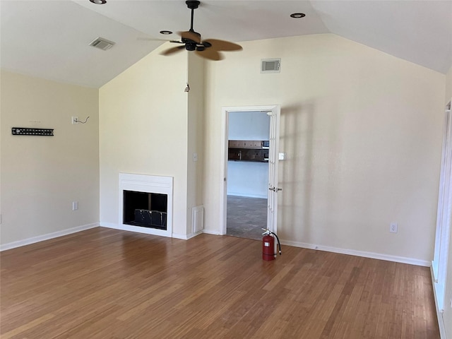 unfurnished living room with hardwood / wood-style flooring, ceiling fan, and lofted ceiling