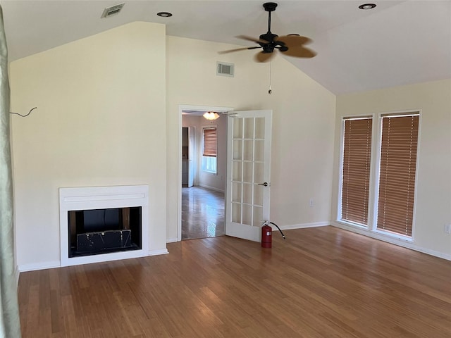 unfurnished living room with french doors, ceiling fan, vaulted ceiling, and hardwood / wood-style floors