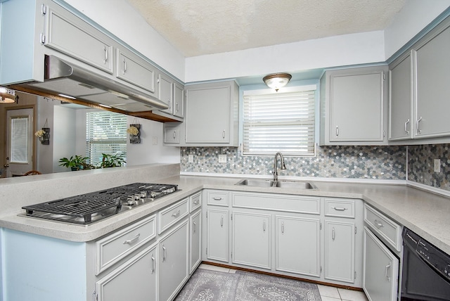 kitchen featuring sink, black dishwasher, tasteful backsplash, kitchen peninsula, and stainless steel gas stovetop