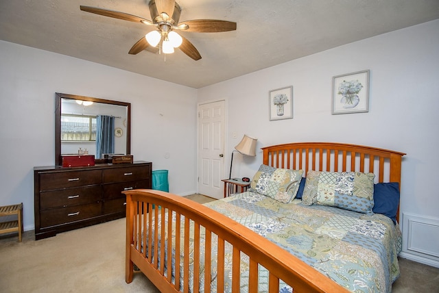 bedroom featuring ceiling fan and light colored carpet