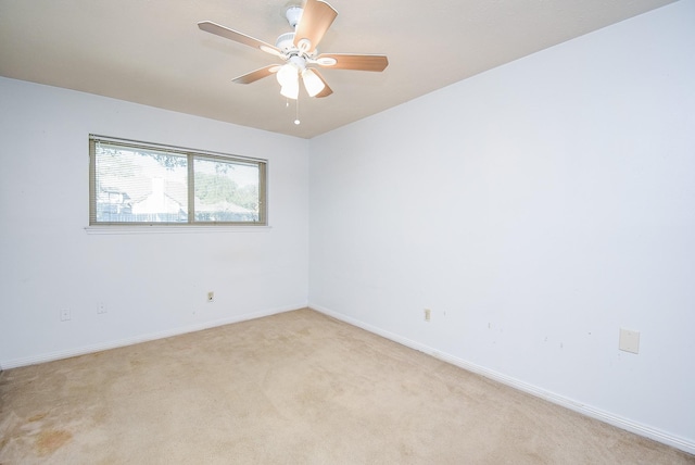 unfurnished room with ceiling fan and light carpet