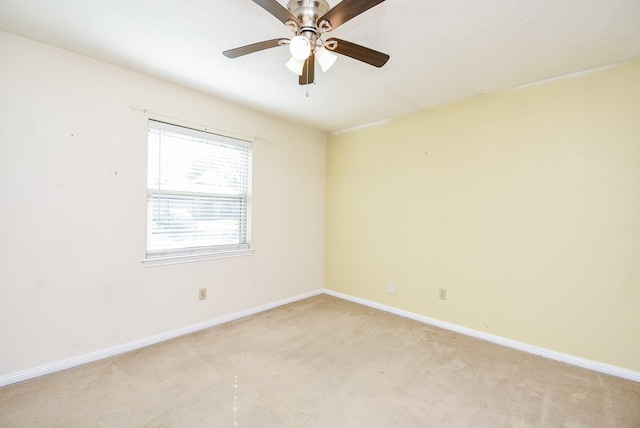 empty room featuring ceiling fan and light colored carpet