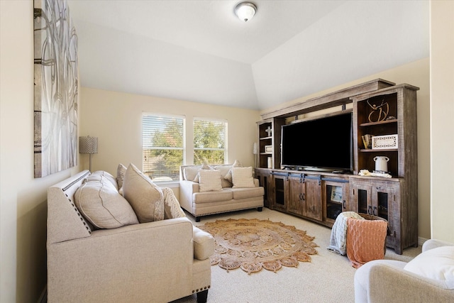 carpeted living room featuring lofted ceiling