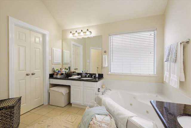 bathroom featuring a tub to relax in, tile patterned flooring, vanity, and lofted ceiling