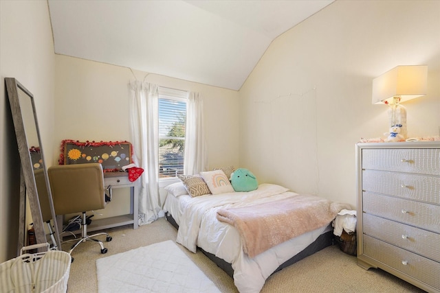 bedroom featuring light colored carpet and vaulted ceiling