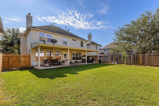 rear view of house with a lawn, a patio area, and an outdoor hangout area