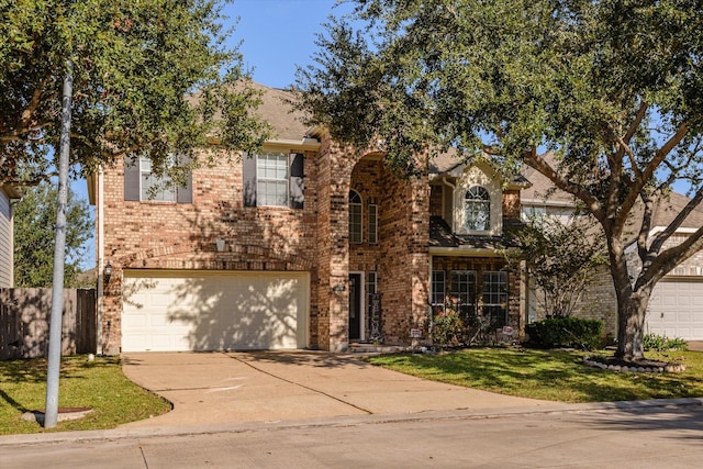 view of front of property featuring a front yard and a garage