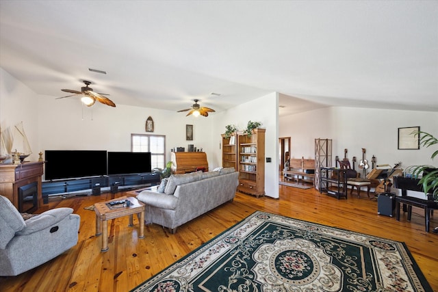 living room with ceiling fan and hardwood / wood-style flooring