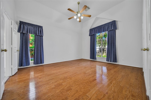 unfurnished room featuring hardwood / wood-style flooring, ceiling fan, and high vaulted ceiling