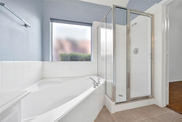 bathroom featuring plus walk in shower and tile patterned floors