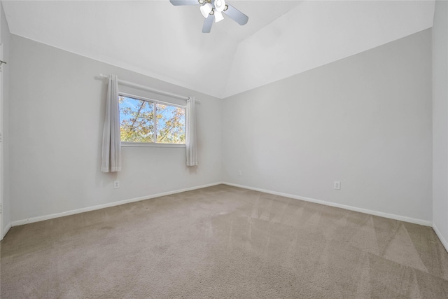 carpeted spare room with ceiling fan and lofted ceiling