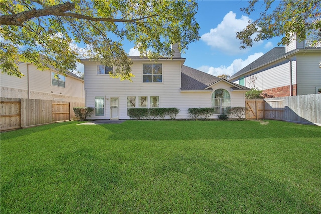 back of house featuring a yard