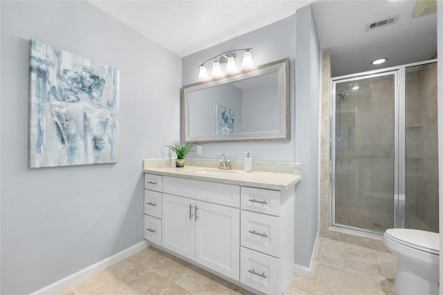 bathroom with tile patterned floors, vanity, an enclosed shower, and toilet