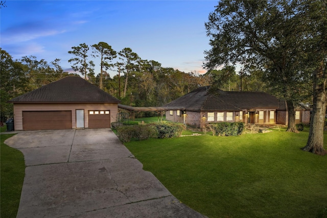 view of front of property with a yard and a garage