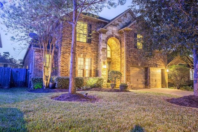 view of front of house with a garage and a front lawn