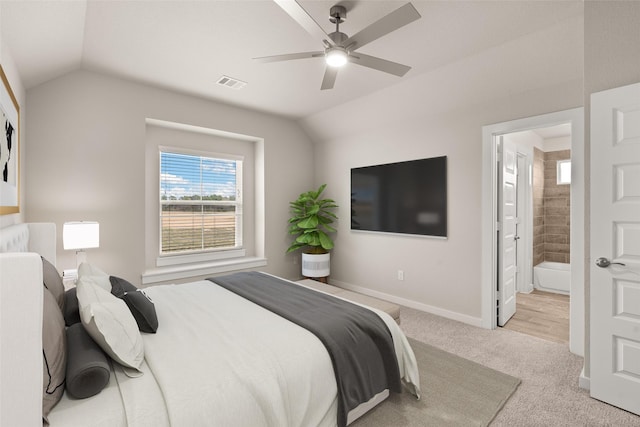 carpeted bedroom featuring ensuite bathroom, ceiling fan, and lofted ceiling