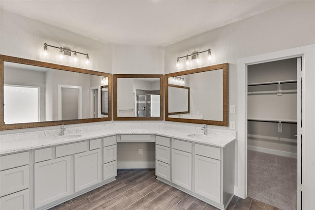 bathroom featuring hardwood / wood-style floors, vanity, and an enclosed shower