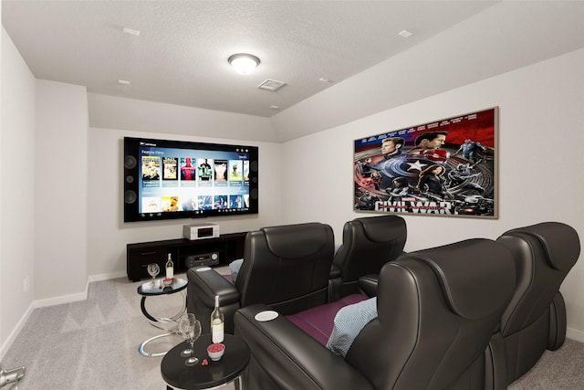 cinema featuring a textured ceiling and light carpet