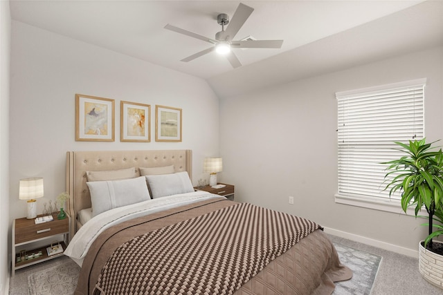 carpeted bedroom featuring ceiling fan and vaulted ceiling